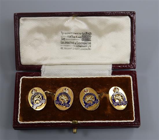 A cased pair of George V 9ct gold and enamel military Trans Jordan Frontier Force cufflinks, gross 10.9 grams.